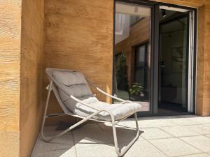 a rocking chair sitting outside of a house at Apartament z Tarasem Parking Smart TV Wi-Fi in Sosnowiec