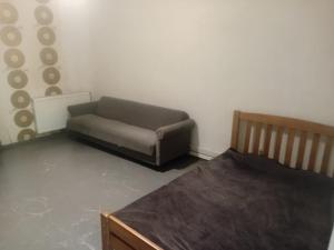 a living room with a couch and a bed at borjomi downtown in Borjomi