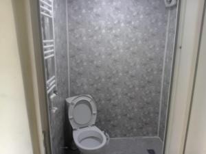a bathroom stall with a toilet and a shower at borjomi downtown in Borjomi +8 photos