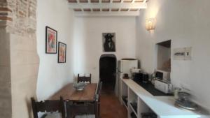 a dining room with a table and a refrigerator at Casa Dulce in Vejer de la Frontera