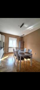 a dining room with a table and chairs at Panorama View in Niš