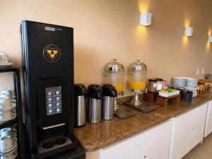a coffee machine sitting on a counter in a kitchen at Hotel Cantareira in Niterói