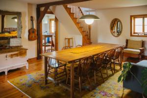 a dining room with a wooden table and chairs at Triangle de l'Île Chambre La Yogi in Saint-Laurent-de-l'ile d'Orleans