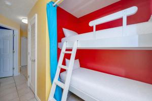 a bunk bed room with two bunk beds and a ladder at The Dunes 503 in Gulf Shores
