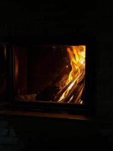 a fire is coming out of a brick oven at Remizovka Mount in Almaty