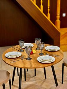 a wooden table with plates and glasses on it at Remizovka Mount in Almaty