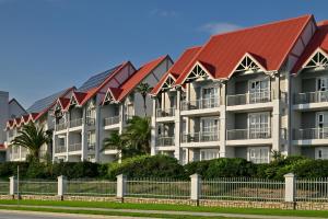 a row of apartment buildings with red roofs at Courtyard Hotel Gqeberha in Port Elizabeth