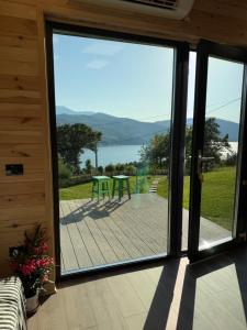 a sliding glass door leading to a patio with a table at Vis de Munte Chalet in Buhalniţa +12 photos
