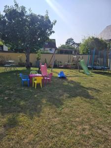 a group of chairs in a yard with a playground at Maison confortable à Ver-sur-Mer avec jardin privé in Ver-sur-Mer