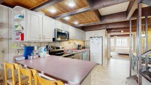 a kitchen with white cabinets and a counter top at White Sands Village 27 in Ocean City