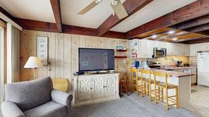 a living room with a television and a kitchen at White Sands Village 27 in Ocean City