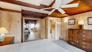 a bedroom with a ceiling fan and wooden walls at White Sands Village 27 in Ocean City +15 photos