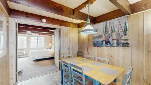 a dining room with a table and chairs and a bedroom at White Sands Village 27 in Ocean City