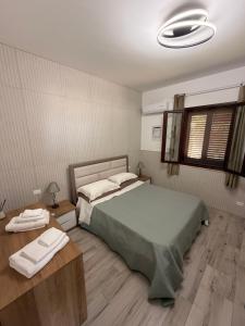 a bedroom with a large bed and two tables at Villa Marina Luxury in Balestrate