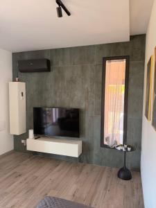 a living room with a large flat screen tv on a wall at Villa Marina Luxury in Balestrate