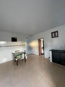 a living room with a table and a tv at Beach House in Barra dos Coqueiros