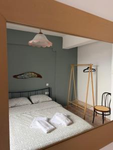 a bedroom with a bed with two towels on it at Portitsa View Guesthouse in Spílaion