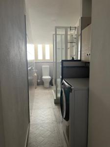 a bathroom with a toilet and a washing machine at Domus Enricucciu in Lanusei +16 photos