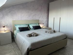 a bedroom with a large bed with towels on it at Domus Enricucciu in Lanusei