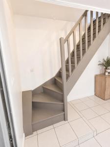 a staircase in a house with white walls at sejour climatisé avec chambres avec ventilateurs in Bourgoin