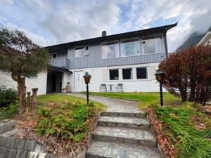 a white house with a pathway leading to it at Fonnagata in Åndalsnes