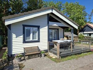 a small house with a bench in front of it at Oase van rust in Poortvliet +7 photos
