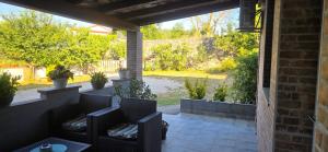 a patio with wicker chairs and a view of a yard at Studio Apartment Loly in Nedeščina