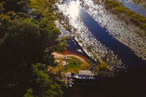 an aerial view of a beach with a boat in the water at The Bell Frog Inn in Maun
