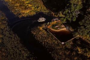 an aerial view of a boat on a river at The Bell Frog Inn in Maun
