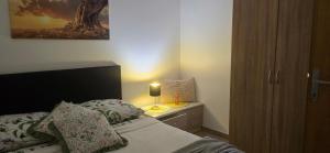 a bedroom with a bed and a lamp on a nightstand at Studio Apartment Loly in Nedeščina