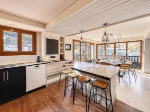 a kitchen and dining room with a table and chairs at L'Ecrin de Jade - Valloire in Valloire