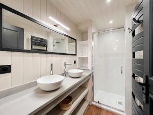 a bathroom with two sinks and a shower at L'Ecrin de Jade - Valloire in Valloire +8 photos