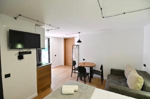 a living room with a couch and a table at Pine Aparthotel in Shekhvetili