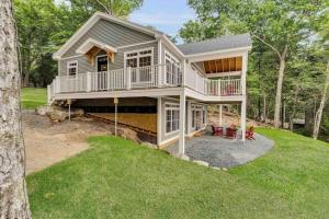 a large house with a wrap around porch at Elegant lakefront home near Bar Harbor & Acadia with modern kitchen, lake views in Orland