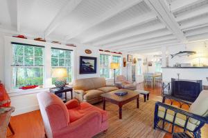 a living room filled with furniture and a fireplace at Waterfront dog-friendly cottage with amazing views, deck, grill, & washer/dryer in Cushing