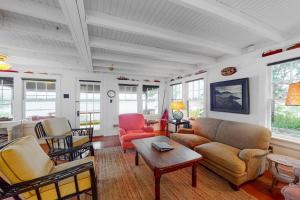 a living room with a couch and chairs at Waterfront dog-friendly cottage with amazing views, deck, grill, & washer/dryer in Cushing