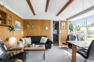 a living room with a couch and a table at FY125-Middelfart-Capellavej-16 in Middelfart