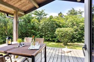 a wooden deck with a wooden table and chairs at FY125-Middelfart-Capellavej-16 in Middelfart