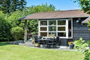 a house with a table and chairs in the yard at FY125-Middelfart-Capellavej-16 in Middelfart