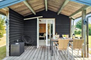 a patio with a table and chairs on a deck at FY125-Middelfart-Capellavej-16 in Middelfart +12 photos