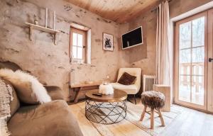 a living room with a couch and a table at Chalet La Tourelle - Valloire in Valmeinier