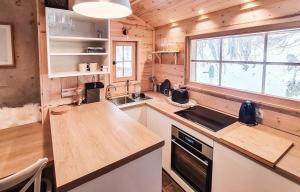 a kitchen with a wooden counter top and a window at Chalet La Tourelle - Valloire in Valmeinier