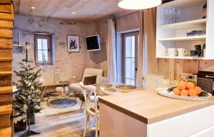 a kitchen and living room with a table and chairs at Chalet La Tourelle - Valloire in Valmeinier +5 photos