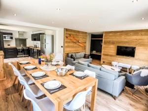 a living room with a wooden table and a couch at L'Étoile D'or - Valloire in Valloire