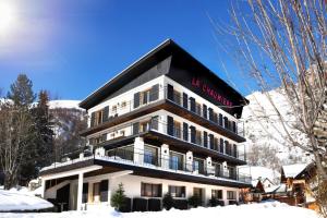 a building with a sign on it in the snow at L'Étoile D'or - Valloire in Valloire