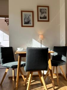 a dining room with a table and four chairs at Apartment 225 in Forstau
