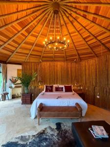 a bedroom with a bed and a chandelier at Villa Pantai Secret Place in Miracatu +204 photos