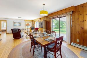 a dining room with a table and chairs at Waterfront stay with scenic deck, grill, smart TVs, shore access - dog-friendly in Penobscot +19 photos