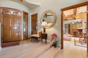 a living room with a chair and a mirror at Elegant ocean view home with breathtaking views, private hot tub & large deck in Rockport