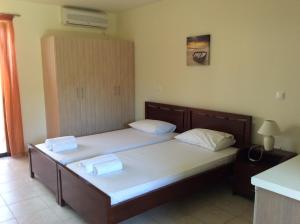 two beds in a hotel room with towels on them at Achladi Beach in Achladi +81 photos